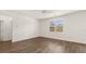 Bright bedroom featuring a ceiling fan, large window and stylish hardwood flooring at 1383 Van Allen Ct, Dacula, GA 30019