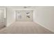 Bright bedroom featuring neutral carpet, two windows, and a ceiling fan at 1383 Van Allen Ct, Dacula, GA 30019