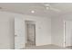 An open, spacious bedroom featuring carpeted floors, a ceiling fan, and two doors at 1383 Van Allen Ct, Dacula, GA 30019