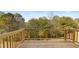 Wooden deck with railing overlooking a lush, green backyard with lots of trees at 1383 Van Allen Ct, Dacula, GA 30019