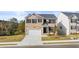 Beautiful two-story brick home with a well-manicured front lawn and two-car garage at 1383 Van Allen Ct, Dacula, GA 30019