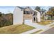Charming two-story home with a well-manicured front lawn and two-car garage at 1383 Van Allen Ct, Dacula, GA 30019