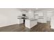 Spacious kitchen with a center island, modern appliances, granite countertops, and dark hardwood flooring at 1383 Van Allen Ct, Dacula, GA 30019
