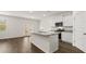 Modern kitchen featuring an island with granite countertops, stainless steel appliances, and ample cabinet space at 1383 Van Allen Ct, Dacula, GA 30019