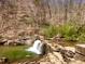 Small waterfall and rocky terrain in a natural and scenic setting at 1383 Van Allen Ct, Dacula, GA 30019
