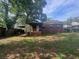 A view of the back of the home highlighting the backyard and covered patio area at 1722 Donnalee Se Ave, Atlanta, GA 30316