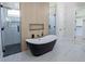 Modern bathroom features a standalone tub, glass shower, and tile flooring for a spa-like experience at 3207 Bold Springs Rd, Dacula, GA 30019