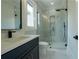 Modern bathroom featuring a frameless glass shower, marble tiles, and stylish fixtures at 3207 Bold Springs Rd, Dacula, GA 30019