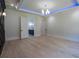 Spacious bedroom with detailed ceiling, accent wall, light wood flooring, and view to the ensuite bathroom at 3207 Bold Springs Rd, Dacula, GA 30019