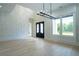 Bright entryway with high ceilings, unique wall decor, and wood floors at 3207 Bold Springs Rd, Dacula, GA 30019