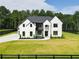 Stunning two-story home with a modern black and white exterior and a perfectly manicured lawn at 3207 Bold Springs Rd, Dacula, GA 30019