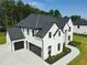 Aerial view of a two-story white brick home, a black roof, and a three-car garage at 3207 Bold Springs Rd, Dacula, GA 30019