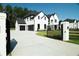 Elegant two-story home with a long driveway and a manicured lawn at 3207 Bold Springs Rd, Dacula, GA 30019