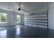 Garage with epoxy floor, overhead door, two windows, and white walls at 3207 Bold Springs Rd, Dacula, GA 30019