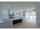 Open concept kitchen with modern appliances, stone countertops, an island, and a view into the living room at 3207 Bold Springs Rd, Dacula, GA 30019