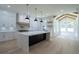 Spacious open kitchen with an island, custom cabinets, modern lighting, and stainless-steel appliances at 3207 Bold Springs Rd, Dacula, GA 30019