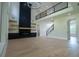 Spacious living room featuring a modern fireplace, open staircase, high ceilings, and hardwood floors at 3207 Bold Springs Rd, Dacula, GA 30019
