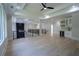 Spacious living area with coffered ceilings, modern lighting, and light hardwood floors at 3207 Bold Springs Rd, Dacula, GA 30019