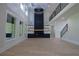 Bright open-concept living room with a statement fireplace, open staircase, chandelier, and large windows at 3207 Bold Springs Rd, Dacula, GA 30019