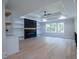 Bright living room with built-in shelves, fireplace, and large windows at 3207 Bold Springs Rd, Dacula, GA 30019