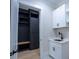 Mudroom with custom dark built-ins, a wood bench, and access to a laundry area at 3207 Bold Springs Rd, Dacula, GA 30019