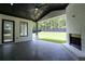 Covered patio with a white-bricked fireplace and backyard view through large windows at 3207 Bold Springs Rd, Dacula, GA 30019