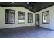 A spacious outdoor living area with a brick wall, tile floors, and large windows at 3207 Bold Springs Rd, Dacula, GA 30019