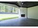 Covered patio with a ceiling fan, fireplace, and an ample view of the backyard at 3207 Bold Springs Rd, Dacula, GA 30019