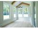 Charming sun room with hardwood floors, vaulted ceiling, and views of the lush backyard at 3207 Bold Springs Rd, Dacula, GA 30019