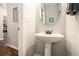 Bathroom sink with pedestal, complemented by modern fixtures, creating a clean and functional space at 429 Mountain View Ln, Woodstock, GA 30188