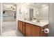 Bathroom vanity featuring double sinks, tiled floors, and decorative mirror at 429 Mountain View Ln, Woodstock, GA 30188