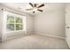 This bedroom features a large window, carpet, and a ceiling fan at 429 Mountain View Ln, Woodstock, GA 30188