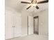This carpeted bedroom features a ceiling fan and a closet for storage at 429 Mountain View Ln, Woodstock, GA 30188