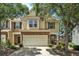 Charming townhome with a stone-accented facade, two-car garage, and well-maintained landscaping at 429 Mountain View Ln, Woodstock, GA 30188