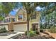 Charming home featuring stone accents, a two-car garage, a well-manicured lawn, and lush landscaping at 429 Mountain View Ln, Woodstock, GA 30188