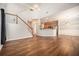 Open-concept living area features hardwood floors, staircase, and kitchen, perfect for modern living at 429 Mountain View Ln, Woodstock, GA 30188