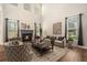 Elegant living room with a cozy fireplace, high ceilings, and large windows, allowing natural light at 429 Mountain View Ln, Woodstock, GA 30188