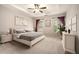 Spacious main bedroom with a tray ceiling, neutral carpet, and natural light at 429 Mountain View Ln, Woodstock, GA 30188