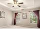 Bright main bedroom with large windows, neutral tones, carpet, and ceiling fan at 429 Mountain View Ln, Woodstock, GA 30188