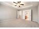 Neutral toned primary bedroom with tray ceilings, carpet, and ensuite bath at 429 Mountain View Ln, Woodstock, GA 30188