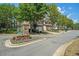 The Bluffs neighborhood entrance featuring manicured landscaping, trees, and several homes in the background at 429 Mountain View Ln, Woodstock, GA 30188