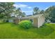 Spacious backyard with a lush green lawn and privacy bushes at 2454 Fairway Sw Cir, Atlanta, GA 30331