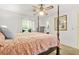 Serene bedroom featuring a four-poster bed, ample natural light, and warm accents at 2454 Fairway Sw Cir, Atlanta, GA 30331