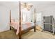 Well-lit bedroom with a four-poster bed, a ceiling fan, and a treadmill at 2454 Fairway Sw Cir, Atlanta, GA 30331