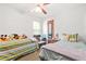 A bedroom featuring two twin beds, colorful teddy bears and carpeted floor at 2454 Fairway Sw Cir, Atlanta, GA 30331