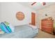 Bedroom showcasing neutral walls, a wooden dresser, and a twin bed at 2454 Fairway Sw Cir, Atlanta, GA 30331