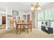 Bright dining area with a sliding glass door and a view of the kitchen bar at 2454 Fairway Sw Cir, Atlanta, GA 30331