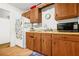Kitchen with wood cabinets, appliances, and an adjacent breakfast area at 2454 Fairway Sw Cir, Atlanta, GA 30331