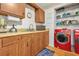 Compact laundry area with washer and dryer hookups, wood cabinets, and ample storage space at 2454 Fairway Sw Cir, Atlanta, GA 30331