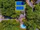 A high-angle view reveals a community pool and tennis courts surrounded by mature, lush trees at 2703 Country Park Dr, Smyrna, GA 30080